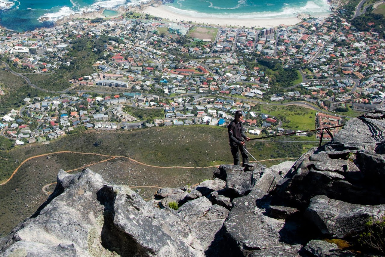 Hiker rappelling off Table Mountain