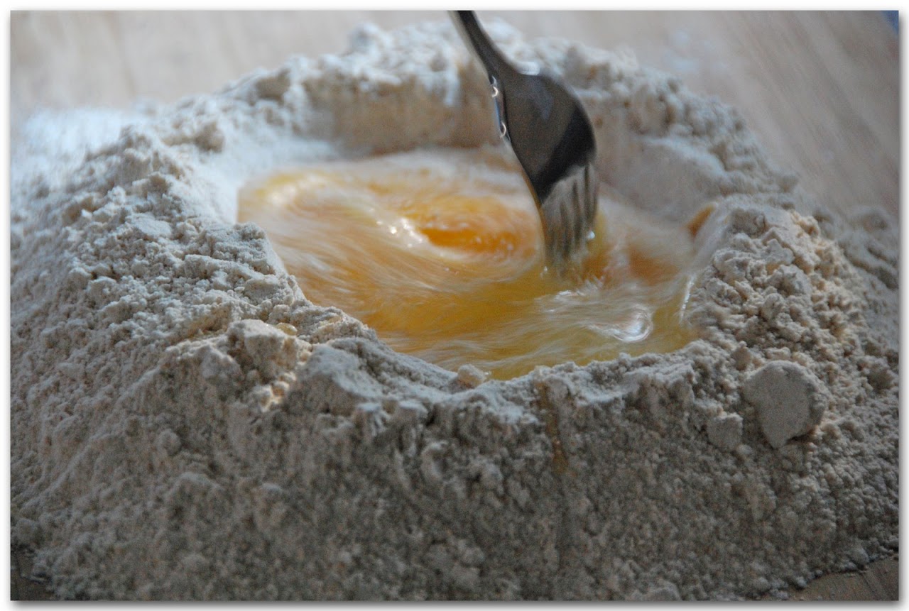 Eggs in flour mound stirred